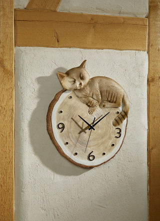 Väggklocka med katt i träd som ser ut som en disk