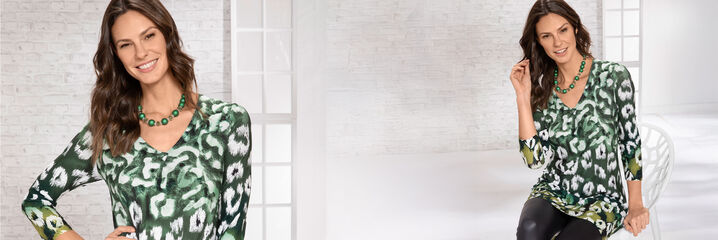 Dam i gr&ouml;nvit tunika och svarta byxor