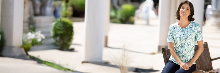 Kvinna i topp och m&ouml;rkbl&aring; byxor