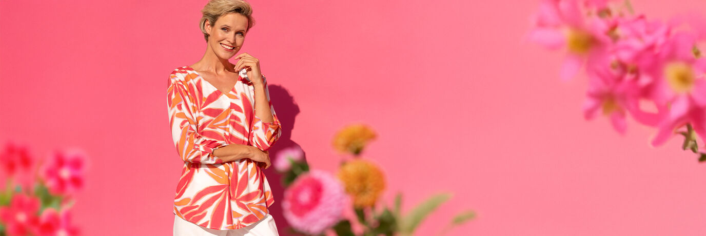 Dam i orangevit blus med 3/4-&auml;rm