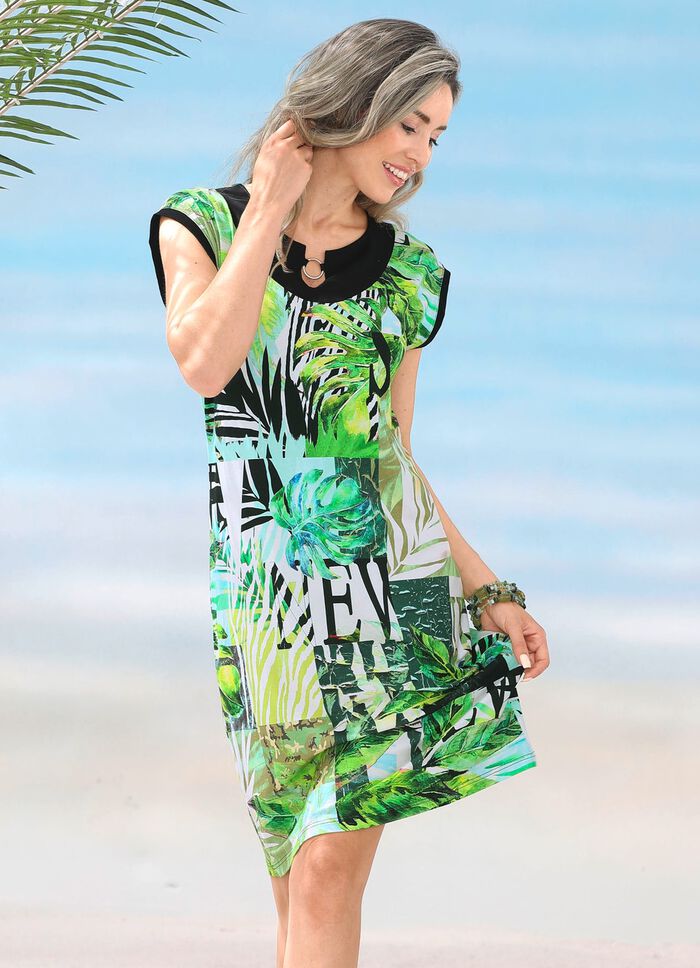 Kl&auml;nning med bl&auml;ckstr&aring;letryck och nedhasade &auml;rmar 