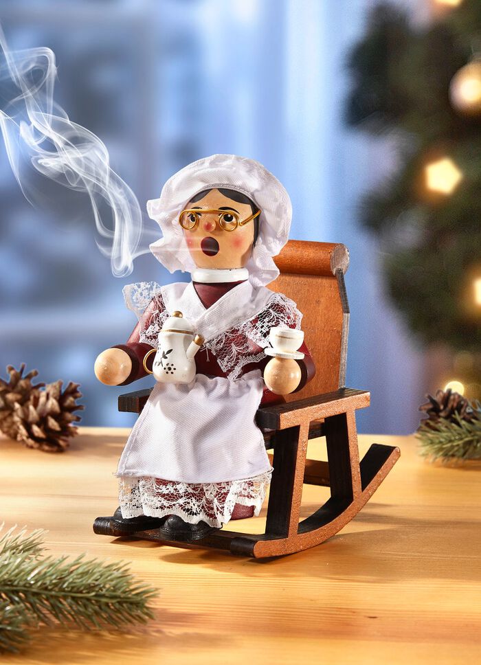 R&ouml;kande figur mormor i en gungstol 