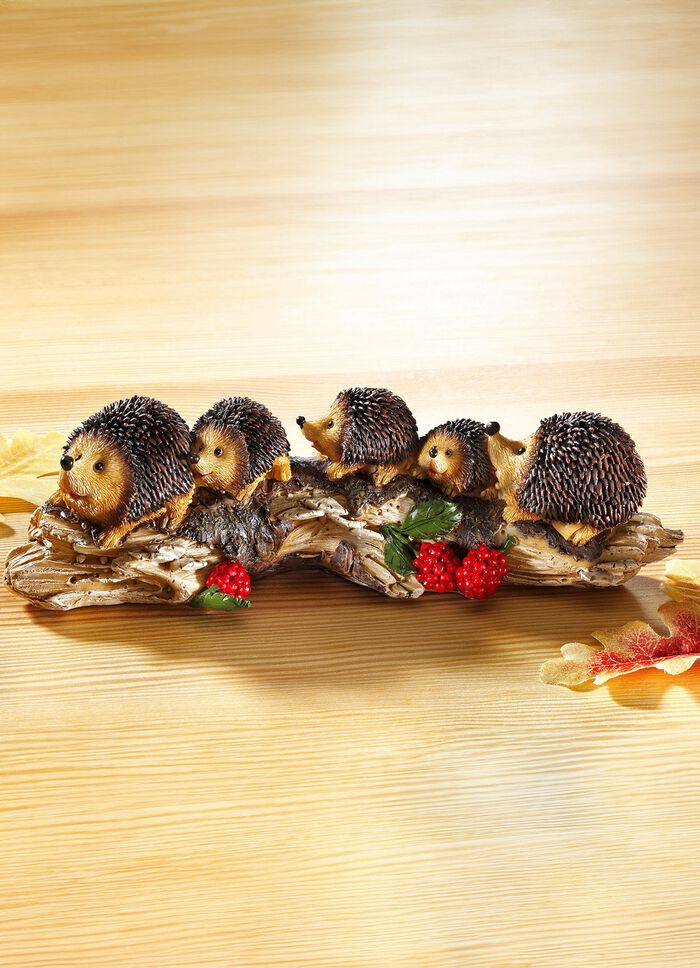 Igelkottsfamilj p&aring; en tr&auml;stam, gjord av stenharts 