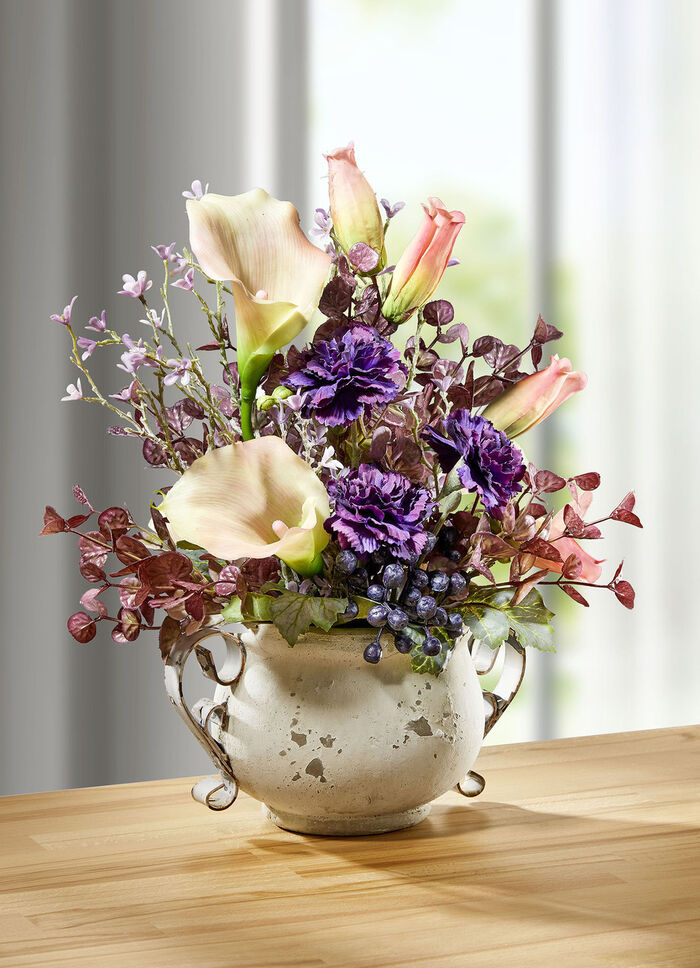 Calla arrangemang i en kruka med handtag 